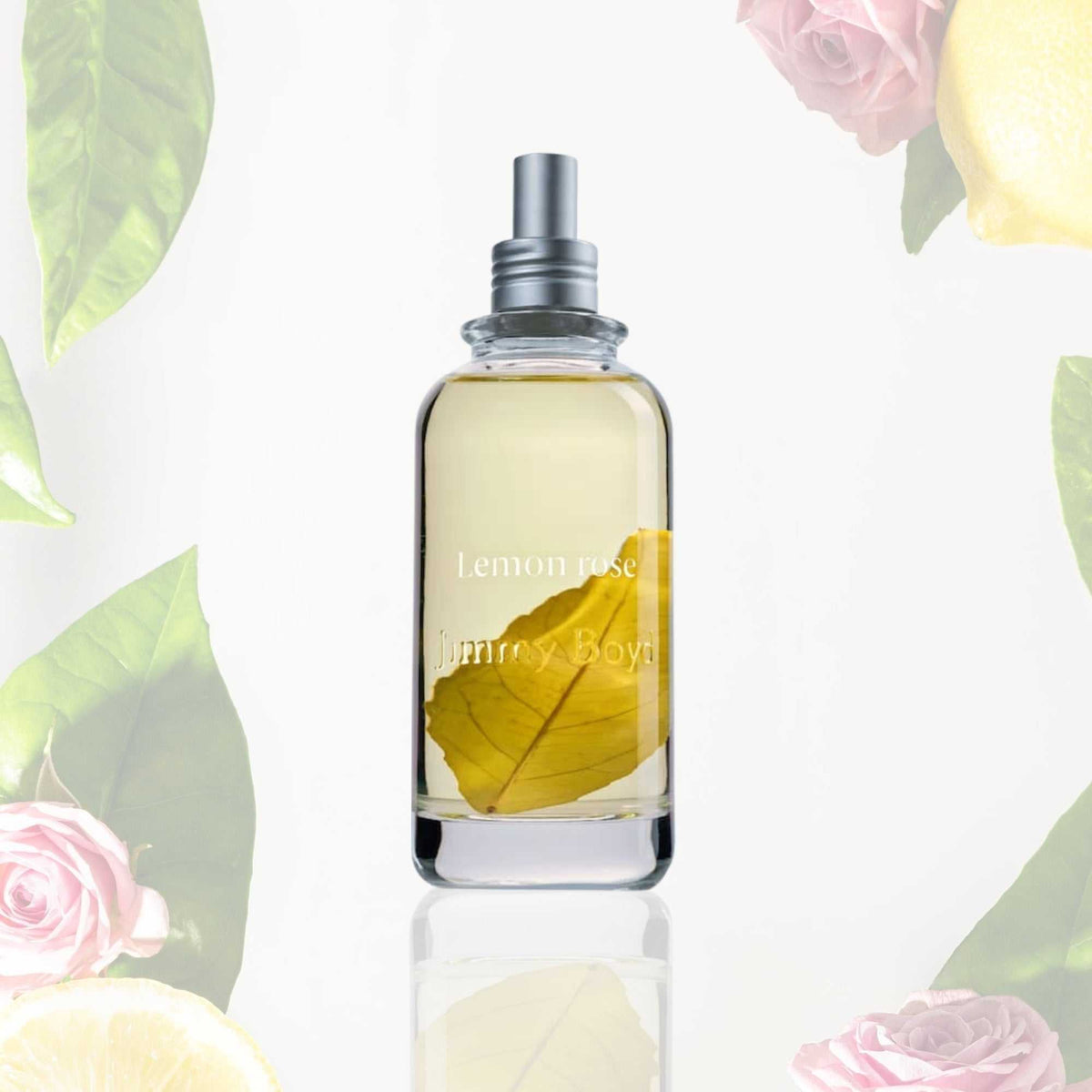 Frasco de Jimmy Boyd Lemon & Rose de 200 ml con hoja de limonero, entre flores y hojas
