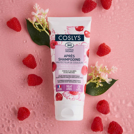 Acondicionador protector del color Coslys en tubo blanco y rosa rodeado de frambuesas