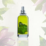 Frasco verde de Jimmy Boyd Spring Rain de 200 ml con hojas en su interior y fondo botánico