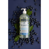 Botella con dosificador del gel de ducha Coslys Arándano Silvestre sobre fondo azul con arándanos