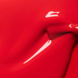 Detalle de la textura fluida y el brillo intenso del esmalte Rojo Coral de Manucurist.